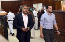 Al-Jazeera television journalists Mohamed Fahmy (L) and Baher Mohamed are seen at a court in Cairo after their retrial, April 22, 2015. PHOTO BY REUTERS/Shadi Bushra