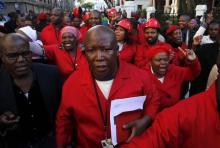 Julius Malema, leader of the opposition Economic Freedom Fighters (EFF), leaves parliament with supporters in Cape Town, August 21, 2014. PHOTO BY REUTERS/Mike Hutchings
