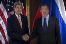 U.S. Secretary of State John Kerry (L) and Russian Foreign Minister Sergey Lavrov shake hands during a photo a photo opportunity in Vienna, October 23, 2015. POTO BY REUTERS/Carlo Allegri
