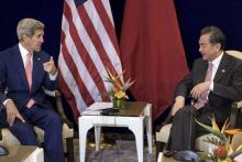US Secretary of State John Kerry (L) and China's Foreign Minister Wang Yi talk before a bilateral meeting at the Putra World Trade Center August 5, 2015 in Kuala Lumpur, Malaysia. PHOTO BY REUTERS/Brendan Smialowski