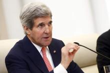 U.S. Secretary of State John Kerry gestures as he speaks to Chinese Foreign Minister Wang Yi (not seen) during their meeting at the Ministry of Foreign Affairs in Beijing