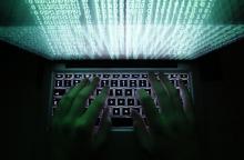 A man types on a computer keyboard in Warsaw in this February 28, 2013 illustration. PHOTO BY REUTERS/Kacper Pempel