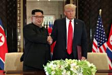 U.S. President Donald Trump shakes hands with North Korea's leader Kim Jong Un after they signed documents that acknowledged the progress of the talks and pledge to keep momentum going, after their summit at the Capella Hotel on Sentosa island in Singapore, June 12, 2018. PHOTO BY REUTERS/Jonathan Ernst