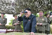 North Korean leader Kim Jong Un looks through a pair of binoculars during an inspection of the Hwa Islet Defence Detachment standing guard over a forward post off the east coast of the Korean peninsula in Pyongyang, July 1, 2014. PHOTO BY REUTERS/KCNA