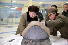 North Korean leader Kim Jong Un looks at a rocket warhead tip after a simulated test of atmospheric re-entry of a ballistic missile, at an unidentified location in this undated file photo released by North Korea's Korean Central News Agency (KCNA) in Pyongyang, March 15, 2016. PHOTO BY REUTERS/KCNA