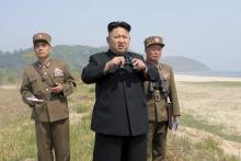 North Korean leader Kim Jong Un (C) guides the multiple-rocket launching drill of women's sub-units under KPA Unit 851, in this undated photo released by North Korea's Korean Central News Agency (KCNA)