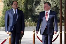 Jordan's King Abdullah (R) and Egyptian President Abdel Fattah al-Sisi review an honour guard at the airport in Amman, December 11, 2014. PHOTO BY REUTERS/Muhammad Hamed