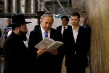 srael's Prime Minister Benjamin Netanyahu (C) reads a prayer with Western Wall Rabbi Shmuel Rabinowitz (L) as his son Yair (R) stands next to him, at the Western Wall, Judaism's holiest prayer site, in Jerusalem's Old City, March 18, 2015. PHOTO BY REUTERS/Ronen Zvulun