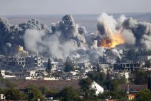 Smoke rises over Syrian town of Kobani after an airstrike, as seen from the Mursitpinar border crossing on the Turkish-Syrian border in the southeastern town of Suruc in Sanliurfa province