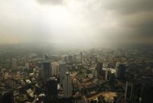 A rain storm clears over central Kuala Lumpur, August 16, 2014. PHOTO BY REUTERS/Olivia Harris