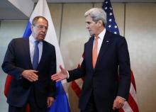 U.S. Foreign Secretary John Kerry and Russian Foreign Minister Sergei Lavrov (L) go for a handshake before their bilateral talks in Munich, Germany, February 11, 2016, ahead of the International Syria Support Group (ISSG) meeting. PHOTO BY REUTERS/Michael Dalder