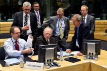 German Finance Minister Wolfgang Schaeuble (C) chats with unidentified officials during a euro zone finance ministers' meeting on the situation in Greece, in Brussels, Belgium, July 12, 2015. PHOTO BY REUTERS/Eric Vidal