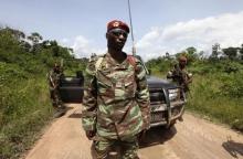 Losseni Fofana of the Ivory Coast Republican forces (FRCI) and commander of the military operation in the Tai area, stands with his men during a patrol on the road to Para village, in the western Tai area near Ivory Coast's border with Liberia, June 17, 2012. PHOTO BY REUTERS/Luc Gnago