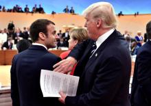 U.S. President Donald Trump claps the shoulder of French President Emmanuel Macron at the start of the first working session. PHOTO BY REUTERS/John MacDougal