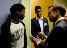 French President Emmanuel Macron talks to Ahmed Adam (L) from Sudan during his visit to a migrant center in Croisilles, northern France, January 16, 2018. At center is translator Elyas Ali, from Chad. PHOTO BY REUTERS/Michel Spingler
