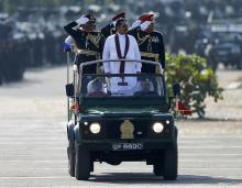 Sri Lanka's President Mahinda Rajapaksa (in white) takes part in a War Victory parade in Matara