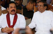 Sri Lanka's newly appointed Prime Minister Mahinda Rajapaksa and President Maithripala Sirisena talk during a rally near the parliament in Colombo, Sri Lanka, November 5, 2018. PHOTO BY REUTERS/Dinuka Liyanawatte