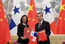 Panama's Vice President and Foreign Minister Isabel de Saint Malo (L) and Chinese Foreign Minister Wang Yi pose with their documents after signing a joint communique on establishing diplomatic relations, in Beijing, China on June 13, 2017. PHOTO BY REUTERS/Greg Baker
