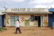 A man walks past the local "Theatre of Dreams" cinema hall within the trading centre near the ancestral home of U.S. President Barack Obama in Nyang'oma village in Kogelo west of Kenya's capital Nairobi, June 23, 2015. PHOTO BY REUTERS/Thomas Mukoya