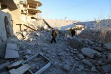 Residents inspect damage after airstrikes by pro-Syrian government forces in Anadan city, about 10 kilometers away from the towns of Nubul and Zahraa, Northern Aleppo countryside, Syria, February 3, 2016. PHOTO BY REUTERS/Abdalrhman Ismail