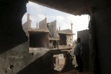 A man stands in his house which was destroyed during clashes between military forces loyal to Libya's eastern government and the Shura Council of Libyan Revolutionaries, an alliance of former anti-Gaddafi rebels who have joined forces with the Islamist group Ansar al-Sharia, are seen in Benghazi, Libya, March 12, 2016. PHOTO BY REUTERS/Esam Omran Al-Fetori