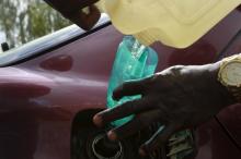 A man pours petrol into a car tank outside the NNPC mega petrol station in Abuja, Nigeria, May 25, 2015. PHOTO BY REUTERS/Afolabi Sotunde