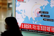 A woman walks past a television broadcasting a news report on North Korea firing ballistic missiles, at a railway station in Seoul, South Korea, March 6, 2017. PHOTO BY REUTERS/Kim Hong-Ji