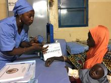 A Marie Stopes nurse explains to mother-of-three Kadidja Toudjani how a contraceptive implant works in Niger's village of Libore, about 20km southeast of the capital Niamey, Niger November 2, 2017. PHOTO BY REUTERS/Tim Cocks