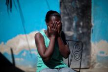 Marieline Jean, who was deported back to Haiti from the United States, covers her face with her hands as she poses for a portrait at the house where she lives, in Port-au-Prince, Haiti, January 30, 2017. PHOTO BY REUTERS/Andres Martinez Casares