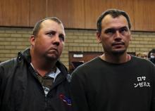 Theo Martins and Willem Oosthuizen (R) appear in court after an online video emerged showing them pushing a black man into a coffin and threatening to burn him alive, at the Middelburg magistrates High Court, in Mpumalanga province, South Africa, November 16, 2016. PHOTO BY REUTERS/Siphiwe Sibeko