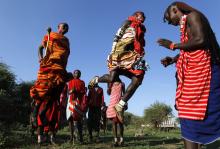 Maasai men sing traditional songs and jump before the Maasai Olympics 2014 at the Sidai Oleng wildlife sanctuary at the base of Mt. Kilimanjaro near the Kenya-Tanzania border in Kajiado, December 13, 2014. PHOTO BY REUTERS