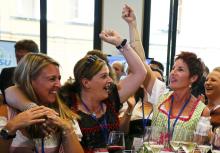 Members of Christian Social Union (CSU), sister party to Christian Democrats (CDU), react as they watch exit polls in Munich