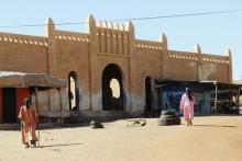 Men walk in front of the main market building in Goundam, Mali, November 7, 2013. PHOTO BY REUTERS/Adama Diarra