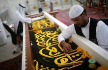 Men embroider the Kiswa, a silk cloth covering the Holy Kaaba, ahead of the annual haj pilgrimage, at a factory in the holy city of Mecca, Saudi Arabia, August 26, 2017. PHOTO BY REUTERS/Suhaib Salem