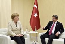 Turkish Prime Minister Ahmet Davutoglu meets with German Chancellor Angela Merkel upon her arrival at Gaziantep airport, April 23, 2016. PHOTO BY REUTERS/Steffen Kugler