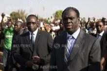 Burkina Faso President Michel Kafondo (R) and Prime Minister Isaac Zida (L) arrive at a memorial service for six people who died during the recent popular uprising in Ouagadougou, December 2, 2014. REUTERS/Joe Penney