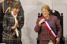 Chile's President Michelle Bachelet smiles next to Senate President Isabel Allende (L), daughter of late former President Salvador Allende, after delivering her annual address at the national congress building in Valparaiso city, northwest of Santiago