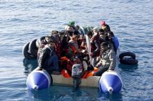 Refugees and migrants are seen on a dinghy as they approach the Ayios Efstratios Coast Guard vessel, during a rescue operation at open sea between the Turkish coast and the Greek island of Lesbos, February 8, 2016. PHOTO BY REUTERS/Giorgos Moutafis