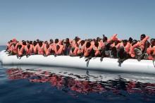 A plastic raft overcrowded with migrants is seen drifting during a search and rescue operation by rescue ship Aquarius, operated by SOS Mediterranean and Doctors without Borders, in central Mediterranean Sea May 18, 2017. Kenny Karpov/SOS Mediteranee/Reuters.