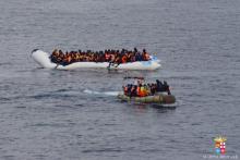 Migrants sit in their boat during a rescue operation of 219 migrants by Italian naval vessel Bettica (not seen) in this February 23, 2016 handout picture provided by Marina Militare. PHOTO BY REUTERS/Marina Militare