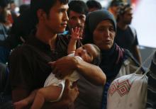 Travelers believed to be migrants leave a train coming from Austria at the railway station in Munich, Germany, August 31, 2015. PHOTO BY REUTERS/Michael Dalder