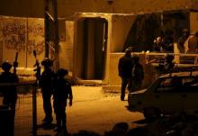 Israeli forces gather near the scene where a Palestinian woman, who the Israeli military said tried to stab an Israeli border policeman, was shot and seriously wounded by Israeli troops, in the West Bank old city of Hebron, February 14, 2016. PHOTO B7 REUTERS/Mussa Qawasma
