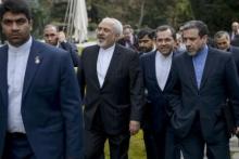 Iranian Foreign Minister Javad Zarif (C) walks with others after a meeting with US Secretary of State John Kerry and other US officials at the Beau Rivage Palace Hotel March 27, 2015 in Lausanne, Switzerland. PHOTO BY REUTERS/Brendan Smialowski