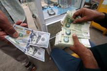 Iranian rials, U.S. dollars and Iraqi dinars are seen at a currency exchange shop in Basra, Iraq, November 3, 2018. PHOTO BY REUTERS/Essam al-Sudani