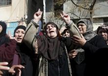 The mother (C) of Palestinian youth Omar Madi, who was shot and killed by Israeli troops on Wednesday, mourns during his funeral in Arroub refugee camp, north of the West Bank city of Hebron, February 11, 2016. PHOTO BY REUTERS/Mussa Qawasma
