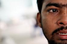 Muhammed Ariful Islam, 22, a Dhaka painter who was held captive on a ship before being abandoned on a remote island, cries at a government shelter in Takua Pa district of Phang Nga, October 17, 2014. PHOTO BY REUTERS/Athit Perawongmetha