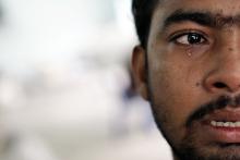 Muhammed Ariful Islam, 22, a Dhaka painter who was held captive on a ship before being abandoned on a remote island, cries at a government shelter in Takua Pa district of Phang Nga October 17, 2014. PHOTO BY REUTERS/Athit Perawongmetha