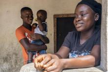 Musa Pabai holds his son Oliver while looking at his girlfriend Hannah Wright (L-R), upon meeting them for the first time after surviving Ebola, at his home in Walakor, February 19, 2015. PHOTO BY REUTERS/Ricci Shryock