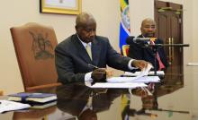 Uganda President Yoweri Museveni signs an anti-homosexual bill into law at the state house in Entebbe, 36 km (22 miles) south west of capital Kampala