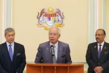Malaysia's Prime Minister Najib Razak (C) announces the appointment of new Deputy Prime Minster Ahmad Zahid Hamidi (L) beside Malaysia's Chief Secretary to the Government Ali Hamsa (R) following a cabinet reshuffle in Putrajaya, Malaysia, July 28, 2015. PHOTO BY REUTERS/Mohd Fadli Hamzah